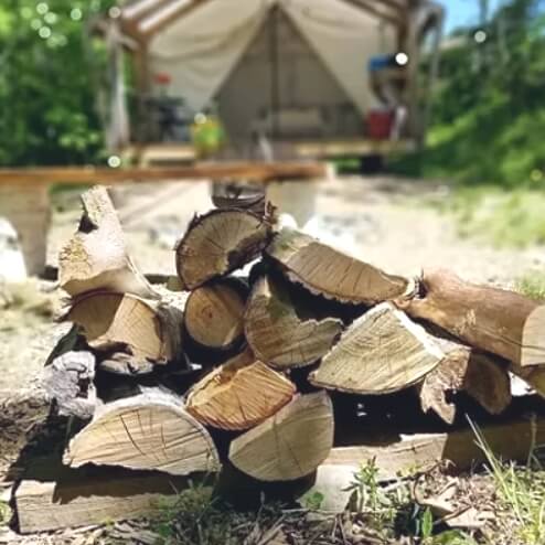 Firewood bundle add-on for glamping campfires at NATURA Wilderness Resort, Nova Scotia
